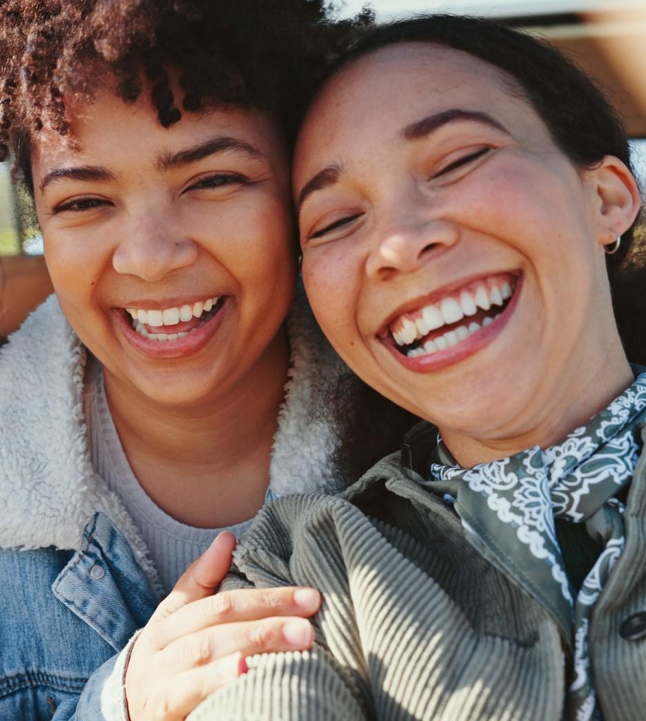 Multi-generational family standing together with hands joined — community and family care