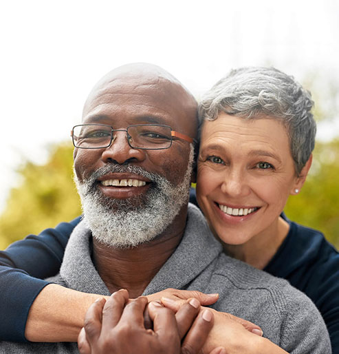 A happy older couple smiling together — trusted dental care for every stage of life