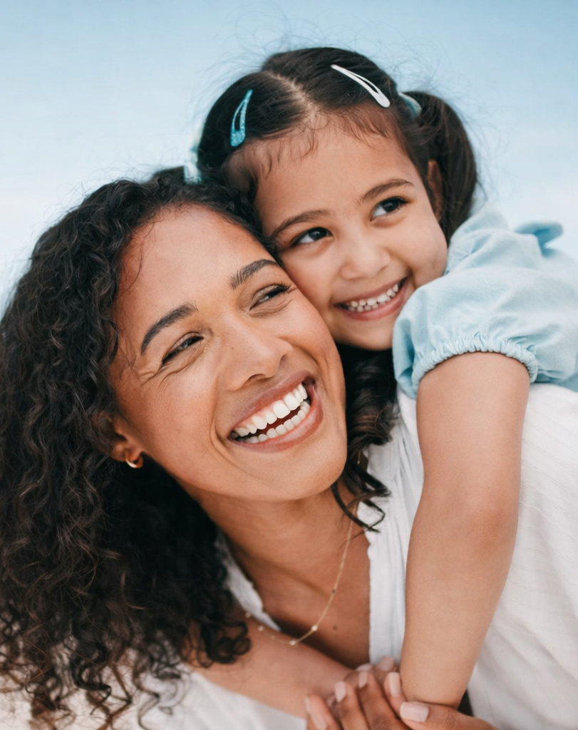A happy mother and daughter smiling together — Orchards Smiles Dental, Edmonton